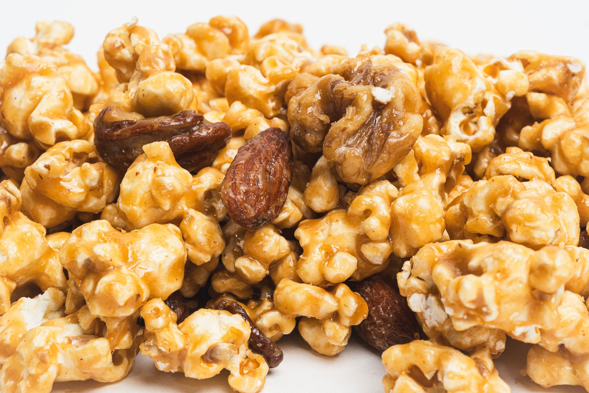 Poppin Toffee Butter Toffee popcorn with nuts on a white background